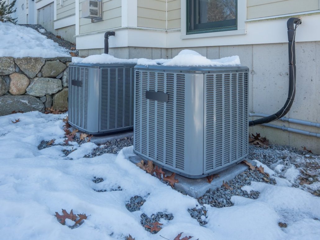 Getting an HVAC system ready for winter on the outside of the house